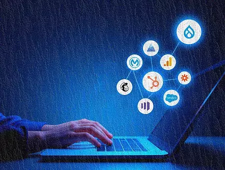 A person engaged in typing on a laptop, which displays several icons, suggesting a busy digital workspace.